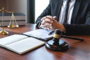 Professional male lawyer or counselor working with legal case document contract in office