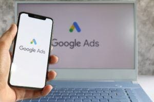 Google Ads logo on computer screen and Google Ads logo on mobile phone screen